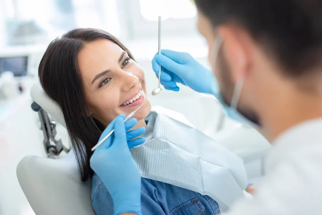 Dentist examining patient in clinic